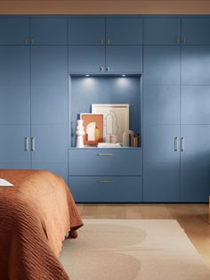 a bedroom with blue cabinets and an orange bed in it's centerpieces