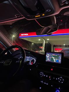 the interior of a car with an electronic display on the dash board and steering wheel