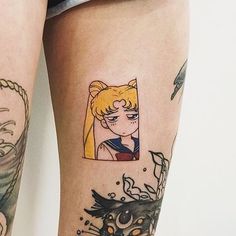 a woman's legs with tattoos on them and an image of a cat in the background