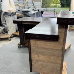 a workbench in the middle of a workshop with tools and materials around it