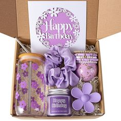 a birthday gift box filled with candles, cookies and other items for someone's special occasion