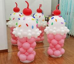 three ice cream cones with sprinkles and cherries on them in front of a mirror