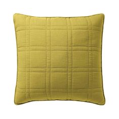 a yellow pillow on a white background