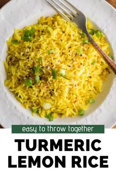 a white plate topped with yellow rice and green onions