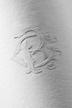 a white paper with the letter b on it's side and an ornate design