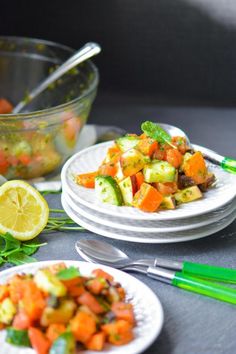 there is a salad with cucumbers and carrots on the plate next to it