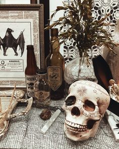 a table topped with bottles and a skull