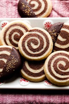 chocolate covered cookies with sprinkles on a plate