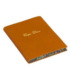 an orange book with gold lettering on it