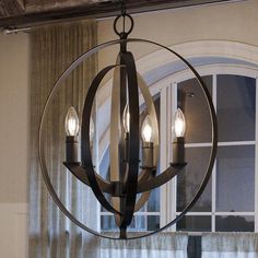 a chandelier hanging in front of a window