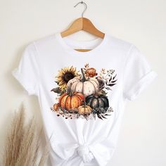 "Fall in love with these soft & comfy Bella Canvas t-shirts that are sure to be your new \"must have more\" shirts! Pumpkin t-shirt Autumn Vibes t-shirt Autumn shirt Fall Vibes tee Fall Colors t shirt Womens Fall tee Womens Fall Harvest tee Harvest Vibes shirt Festive tee Gift Womens shirt Gift for women Womens gift Recommendations: *For a standard fit, stick with your typical size *For an oversized fit, size up *For a fitted shirt, size down. *Shirts are longer. Great for knots, Tucks, or nice coverage with leggings. *Unisex Cut. works great for Everyone! Women sizes: Small: 2-4 | Medium: 6-8 | Large: 10-12 | XL: 14-16 | 2XL: 18-20 | 3XL: 22-24 | 4XL: 26-28 Men sizes: Select your standard size. Details: *Soft, Breathable, & very comfy Bella + Canvas *Pre-shrunk fabric *Solid Colors: 100% White Graphic Print T-shirt For Fall, White Sublimation Print Top For Fall, Graphic Tee With Sublimation Print For Fall, Fall Sublimation Print Relaxed T-shirt, Fall Sublimation Print Relaxed Fit T-shirt, Fall T-shirt With Sublimation Print In Relaxed Fit, Fall Relaxed Fit T-shirt With Sublimation Print, White T-shirt With Funny Print For Fall, White Graphic Tee For Fall