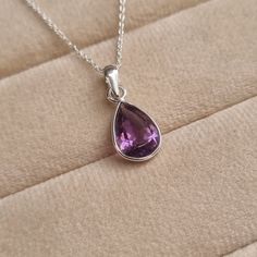 Add a touch of elegance and sophistication to your style with this stunning Amethyst  Pendant. Handcrafted with love, this beautiful pendant features a genuine Amethyst gemstone  suspended delicately from a 925 Sterling Silver chain. Amethyst, the February birthstone, is renowned for its captivating purple hues that evoke a sense of serenity and balance. The pendant's minimalist design makes it perfect for everyday wear or special occasions. Its versatile style complements any outfit, adding a subtle yet radiant touch to your look. Fun Fact!  Amethyst derives from the Greek word amethystos meaning 'not intoxicated'. Greeks believed drinking from goblets studded with amethyst gems would prevent drunkenness and excess!  Gemlogica is an American business and our motive is to create an honest February Birthstone Jewelry, Clean Sterling Silver, Amethyst Gem, February Birthstone, 925 Sterling Silver Chain, Amethyst Pendant, Purple Hues, February Birth Stone, Amethyst Gemstone