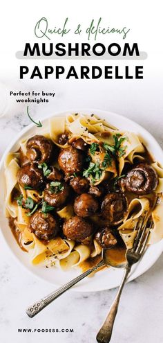 a white plate filled with pasta and meatballs on top of a marble countertop