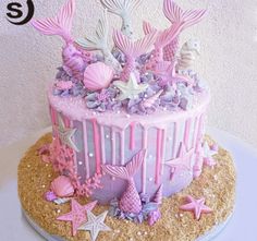 there is a cake decorated with pink and purple decorations