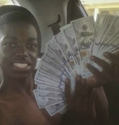 a man holding up money in his hand