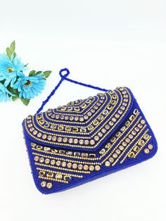 Handmade Blue Clutch Purse, Beaded Clutch Purse, Party Golden Purse, Blue Clutch, Glass Beaded Bag, Blue Beaded Handbag, Blue Box Bag, Blue Crossbody Bag The purse clutch is handmade and adorned with rhinestones and bead embroidery. This purse is stylish, flashy, and has a dazzled look. These purses/bags are for wedding functions, parties, and formal events, or you can use them as casual. These are fancy small bags ideal for money, cards, and makeup touchup kits. The bag has a single compartment Traditional Beaded Bag For Party, Handmade Blue Shoulder Bag For Festivals, Blue Rectangular Shoulder Bag For Festivals, Festival Beaded Clutch, Blue Rectangular Festival Bag, Festive Beaded Handheld Bags, Rectangular Embellished Bags For Celebration, Blue Embroidered Formal Bag, Formal Blue Embroidered Bag