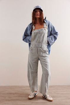 Our top-rated Good Luck Overalls — now in a timeless striped pattern! Featuring the signature barrel-leg fit, you’ll reach for this pair all season long. **Fit:** Bib-and-brace design with wide barrel-leg **Features:** Front bib pocket, tapered knee design, adjustable brace straps, side button detailing, washed railroad stripe pattern **Why We ❤ It:** Toughened-up with moto boots or laid-back with sporty sneakers, this pair has endless ways to wear. | We The Free Good Luck Striped Overalls at Fr Dickies Striped Overalls, Striped Dungarees Outfit, Striped Overalls Outfits, Dungaree Outfit, Overalls 90s, Overalls Outfits, Striped Overalls, Overalls Outfit, Sporty Sneakers