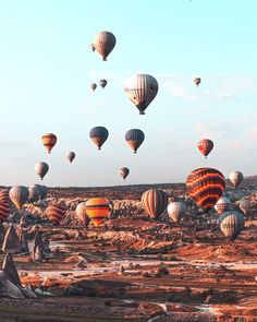 many hot air balloons are flying in the sky