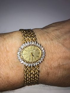 "What a beautiful way to wear the time. This stunning watch is in 14 kt solid gold case and matching mesh style 14kt bracelet band, custom made to fit a 6.5\" wrist with a safety chain as well as a safety clasp. The watch bezel is studded with diamonds that have a total carat weight of over 1 ct. This watch is a quartz style with minimal maintenance as it only needs to have a battery replacement every few years. The watch and matching band are heavy and well made weighing over 34 grams." Yellow Gold Diamond Watch For Wedding, Elegant Gold Jubilee Bracelet Jewelry And Watches, Elegant Gold Jubilee Bracelet Jewelry, Formal Gold Diamond Jewelry And Watches, Yellow Gold Jewelry For Wedding, Gold Diamond Watch With Jubilee Bracelet As Gift, Yellow Gold Diamond Watch With Jubilee Bracelet For Anniversary, Elegant Gold Diamond Watch With Round Face, Gold Watch With Jubilee Bracelet For Anniversary