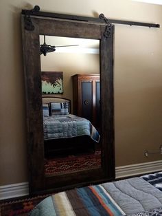 a bedroom with a bed, mirror and sliding doors on the wall above it that says sliding doors can be efficient insulators, enlarring that your home stay warm in the winter and cool