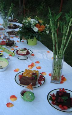 a table topped with lots of desserts and flowers