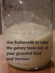 a jar filled with liquid sitting on top of a wooden table