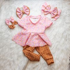 This Beautiful sprinkle Fabric paired with Waffle Cone is so adorable, you will not be able to keep your eyes off your Sweetie.  Your little Sweetheart will be the star of the show when they are rocking this Ice Cream themed set. Choose from adorable baby Peplum Top, Waffle cone pants/leggings, Bow on Nylon, Bow Headband, or All three.  Liverpool fabric ensures longevity of the fit while being breathable. Stylish enough to wear for photo shoot, a visit with family or just around the house.   How Cute Ruffled Sets For Playtime, Cute Ruffled Sets For Playdate, Cute Ruffled Sets For First Birthday, Pink Playtime Sets With Ruffles, Cute Ruffled Sets For Birthday, Sweet Pink Sets With Ruffles, Cute Pink First Birthday Sets, Pink Ruffled Birthday Set, Cute Pink Ruffled Sets