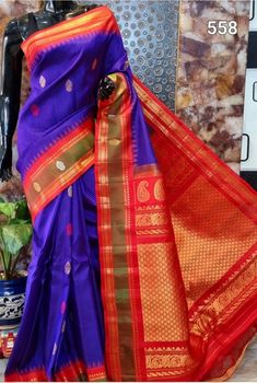 Handloom Gadwal saree with gorgeous red border and pallu. This beautiful Deep Purple saree has woven with nice butta, and border is red with greenish tone and zari. Pallu is rich with red and zari. Perfect for any party. Falls and pico have been done. Don't miss it out, hard to find this colour. Red Bollywood Saree With Border, Red Saree With Border For Puja, Red Saree With Border For Traditional Ceremonies, Bollywood Style Purple Saree With Border, Purple Saree With Border In Traditional Drape, Red Anarkali Saree With Border, Red Paithani Silk Handloom Saree, Red Saree With Border For Festivals, Traditional Purple Saree With Border