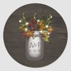 a mason jar with lights and leaves on it is shown in front of a wooden background