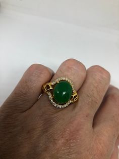 Vintage Lucky Green Nephrite Jade Golden ring Large green nephrite jade Gold finished German Silver Vintage ring, does not tarnish, NOT sterling Size 7, 8, or 9 All rings are shipped free in the US in a nice gift box. Check out our over a THOUSAND great reviews Engraving is $4 per letter and is not always perfect depending on the piece. It can take a few days if the jeweler is busy. This is payable to Paypal Judithsltd@gmail.com Green Cabochon Emerald Ring For Anniversary, Green Oval Cabochon Emerald Ring Collectible, Green Emerald Cabochon Ring For Anniversary, Green Cabochon Ring For Anniversary, Collectible Green Emerald Rings, Green Oval Cabochon Ring For Anniversary, Green Cabochon Gemstones For Anniversary, Collectible Round Green Emerald Ring, Collectible Jade Gemstone Rings