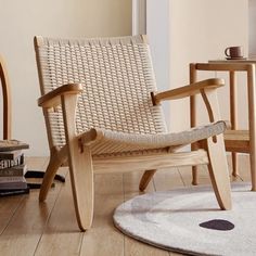 a wooden rocking chair sitting on top of a hard wood floor next to a book