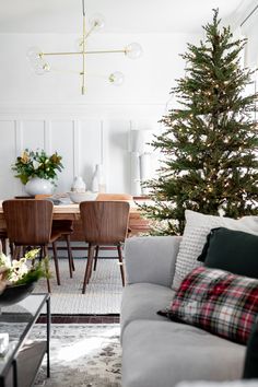 a living room filled with furniture and a christmas tree