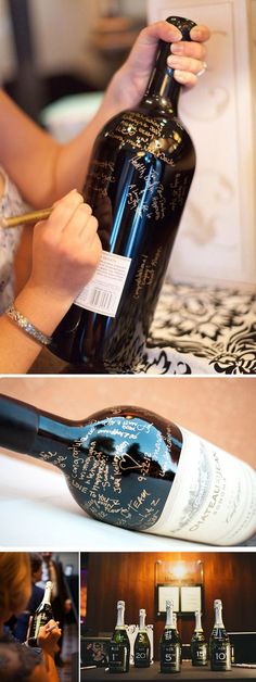 a woman is holding a bottle of wine and writing on it with her fingernails