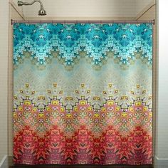 a bathroom with a shower curtain that has an abstract design on the outside and inside