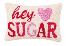 a pillow with the words hey sugar on it and two hearts in pink, red and white