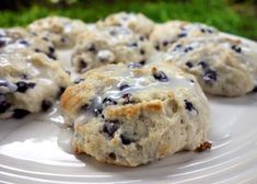 blueberry scones with icing on a white plate