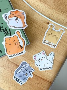 several stickers with cats on them sitting on a table