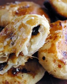 some type of pastry with raisins and cheese on it's crusty surface