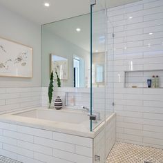 a large bathroom with a walk in shower next to a bathtub