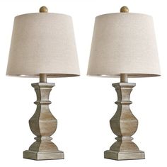 two wooden table lamps sitting next to each other