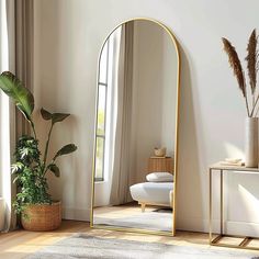 a large mirror sitting on top of a wooden floor next to a potted plant