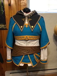 a blue and white costume on display in a room