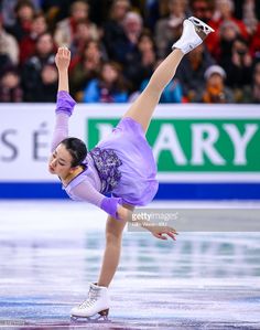 the figure skater is performing her routine in front of an audience