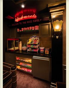 the inside of a fast food restaurant with neon signs above it and snacks on the counter