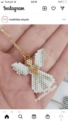 a person is holding a small cross necklace in their hand, with the words instagramn on it