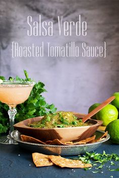 salsa verde roasted tomato sauce with tortilla chips and limes on the side