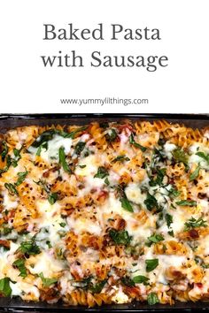 baked pasta with sausage and spinach in a casserole dish on a white background