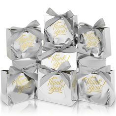 six silver and gold thank you gift boxes with ribbons on them, all wrapped in foil