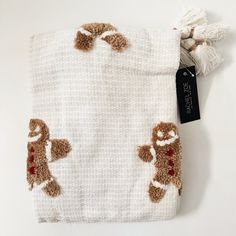 a white blanket with brown and red animals on it