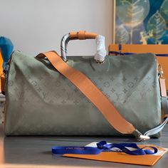 Keepall 50 travel soft bag, a special edition design based on the key fabrics in the 2018-19 autumn and winter men's fashion show. Gray Monogram Titanium canvas body with natural cowhide leather trim, fabric handles and a detachable leather shoulder strap with embossed logo. 

Dimensions: 50x29x23cm Designer Travel Bag With Large Capacity, Designer Travel Bag With Large Capacity And Top Handle, Designer Travel Bag With Top Handle And Large Capacity, Designer Top Handle Travel Bag With Large Capacity, Designer Large Capacity Shoulder Bag For Travel, High-end Travel Bag With Leather Handles, Designer Large Capacity Double Handle Travel Bag, Designer Top Handle Duffle Bag With Large Capacity, Designer Tote Luggage For Everyday Use